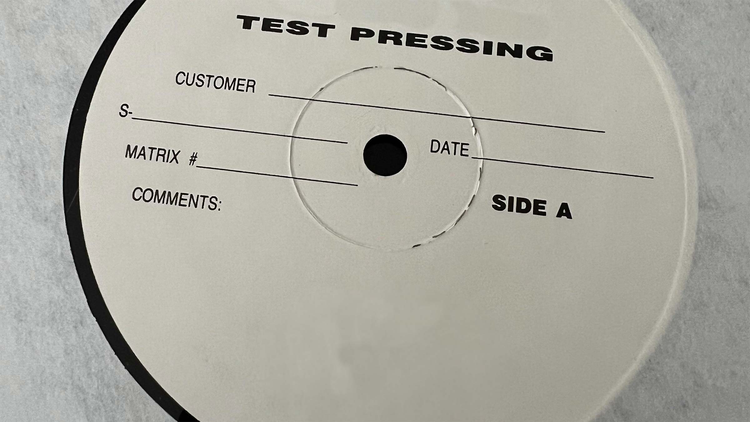 A twelve inch vinyl record test pressing